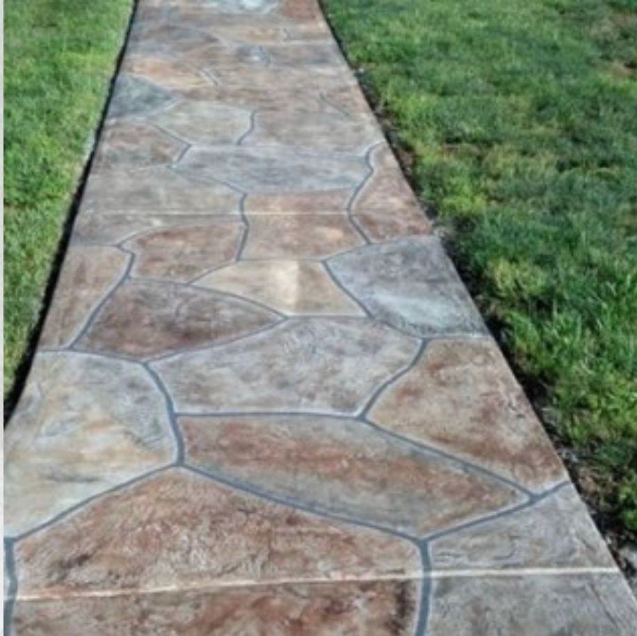 Stamped flagstone-pattern concrete walkway with a colored stain